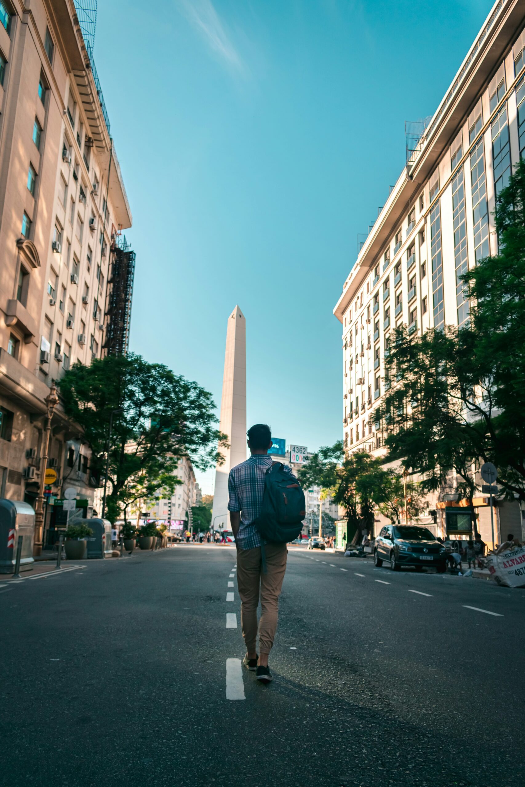 A young man walks down an empty street in Buenos Aires towards the famous Obelisk. Building your ideal study abroad experience means going deep in local relationships.